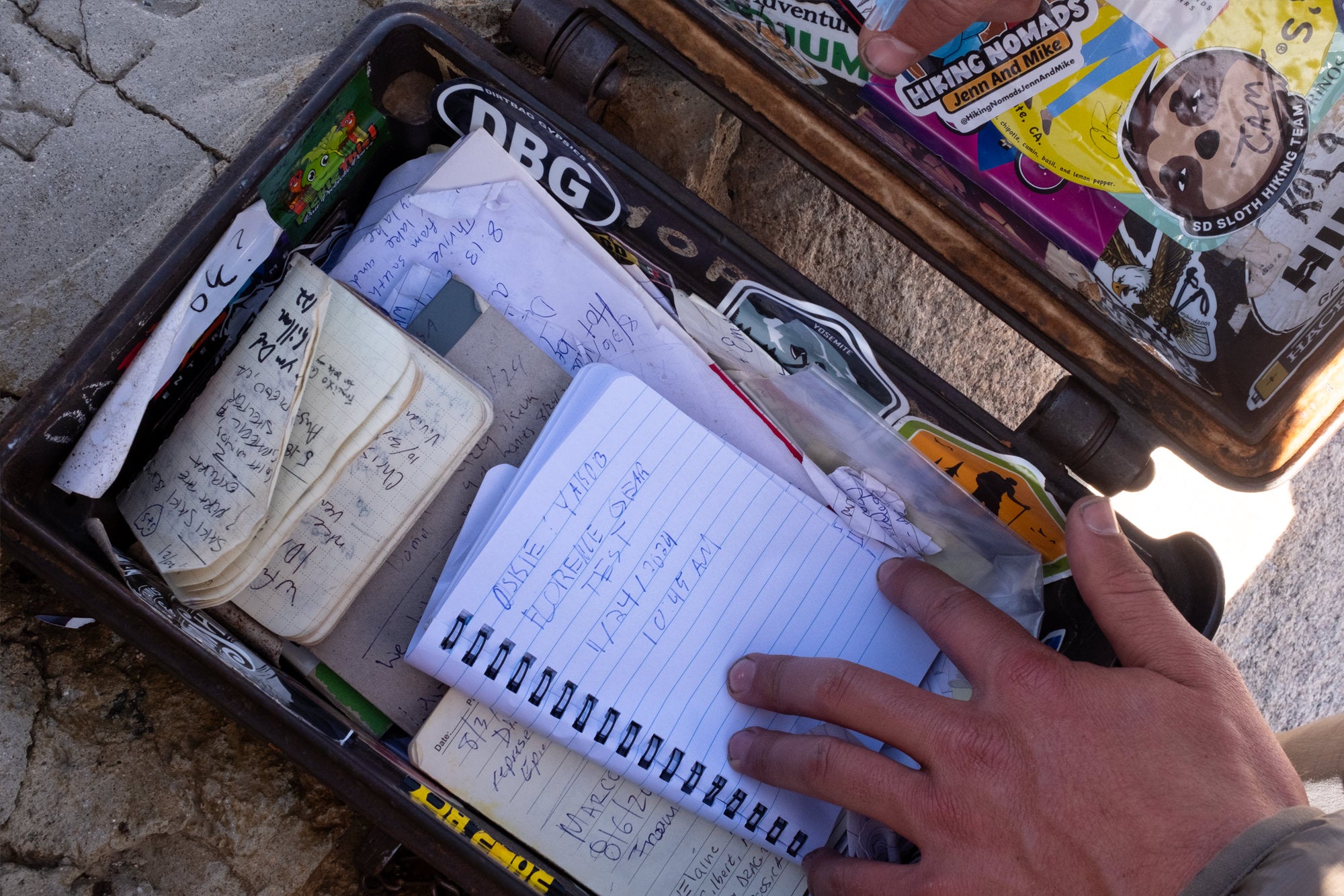 Box of notebooks and notes by hikers at the end of a hike from a Florence gear test