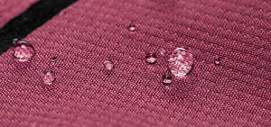 Closeup shot of a water droplet showing the water repellency of C0 DWR on Florence Marine X boardshorts