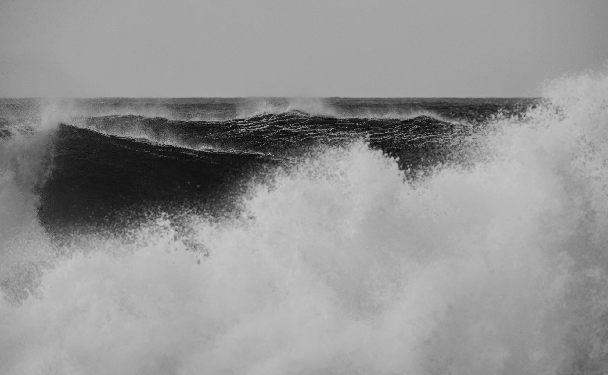 Black and white landscape image of large breaking waves