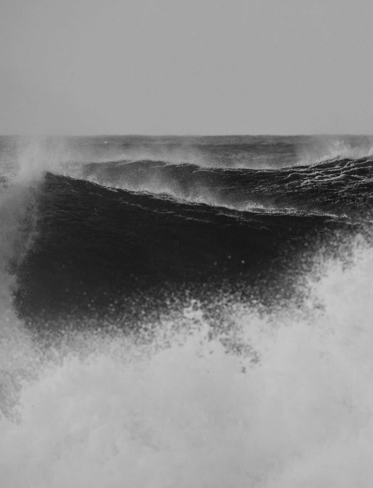 Black and white landscape image of large breaking waves