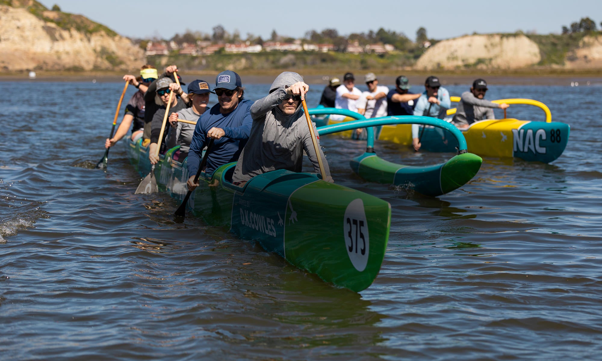 2 6-person Outrigger Canoes in the water with Florence members paddling