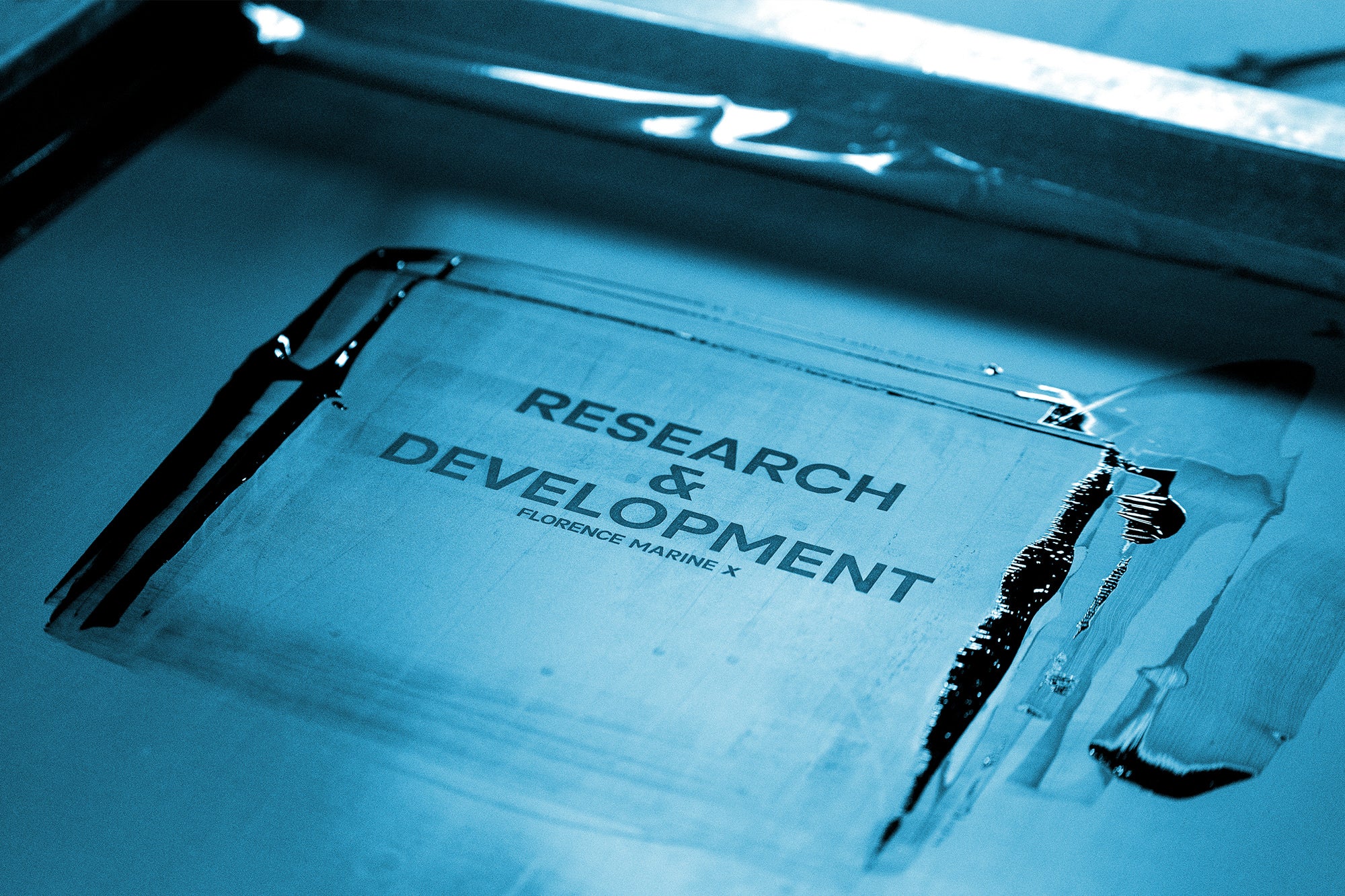 A screen for printing that says "Research & Development" and "Florence Marine X" smaller underneath with black ink
